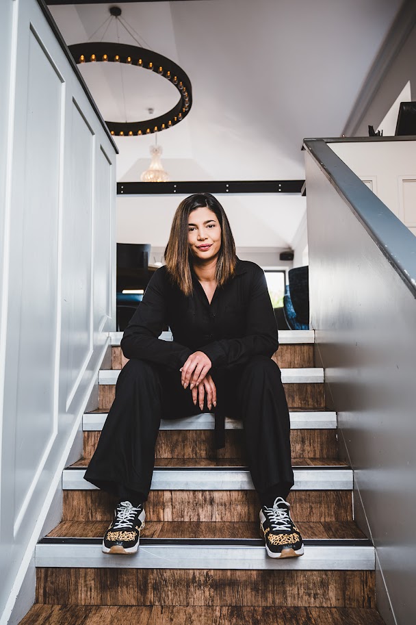 Freya Jones sitting on a staircase in her studio